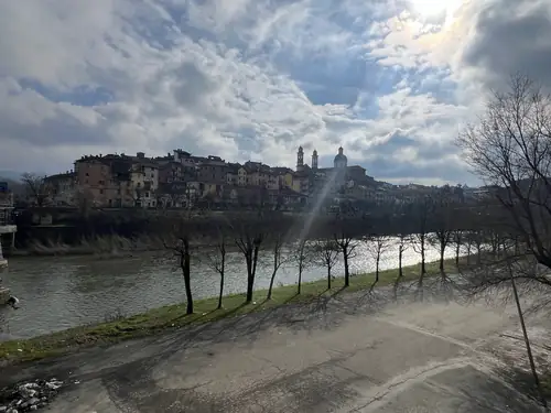 Riverbank and distant hill town