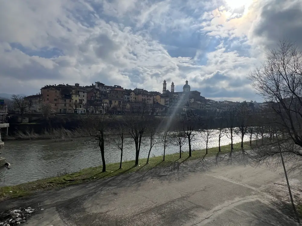 Riverbank and distant hill town